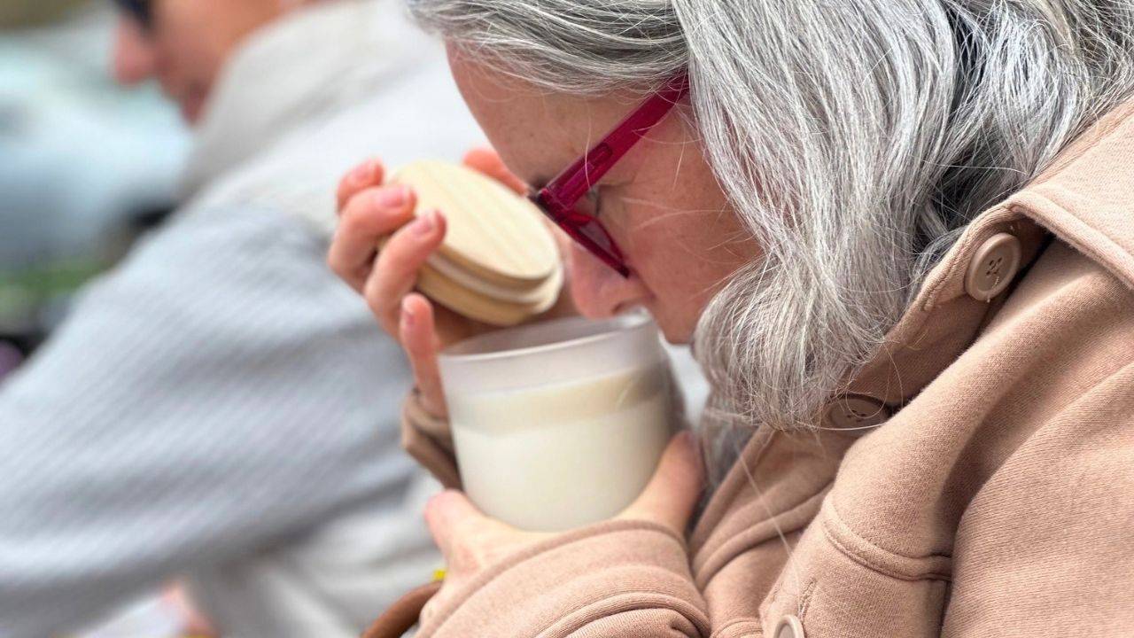 person smelling an artisan made candle