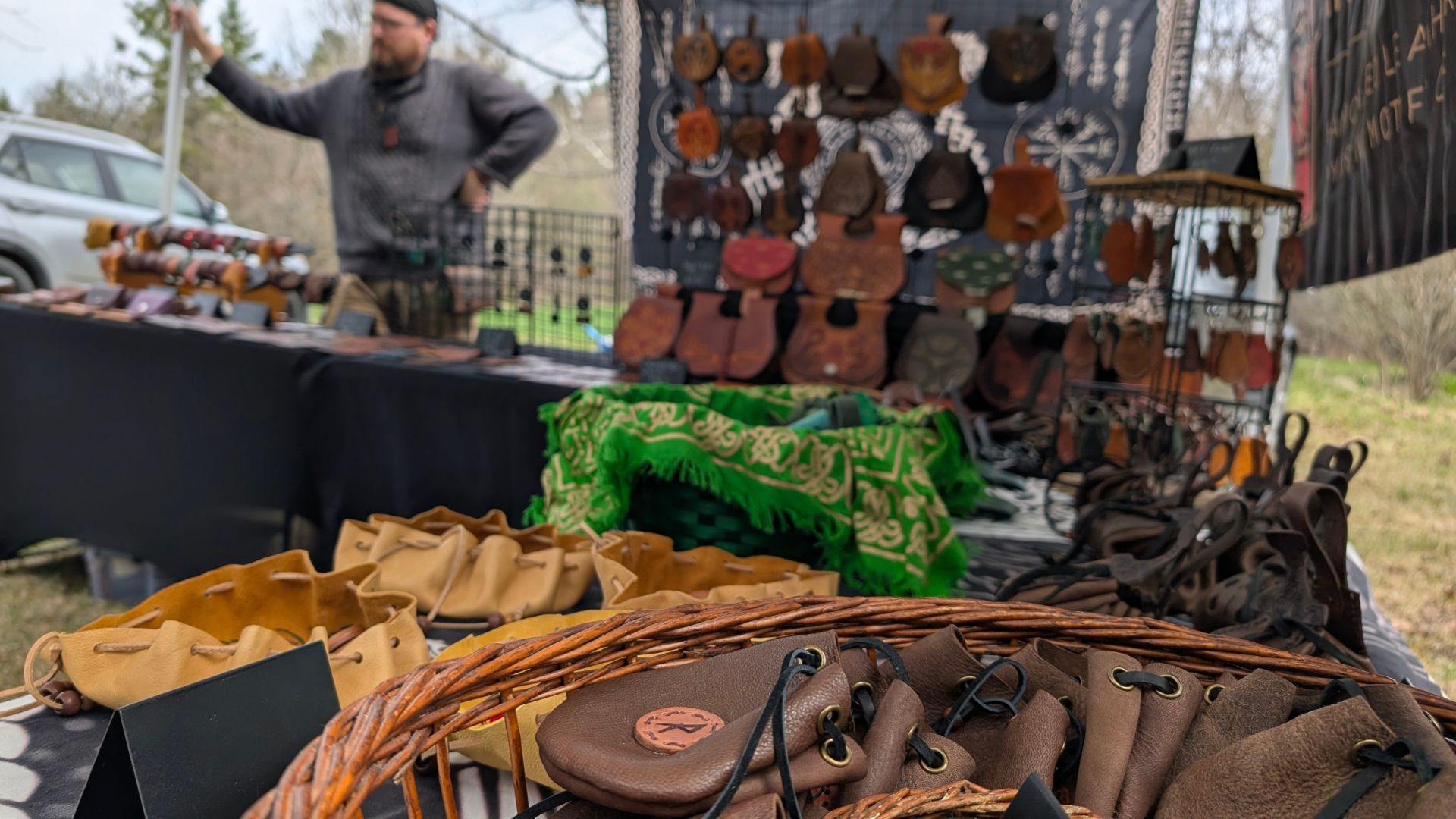 a vendor stall with artisan made leather pouches and bags