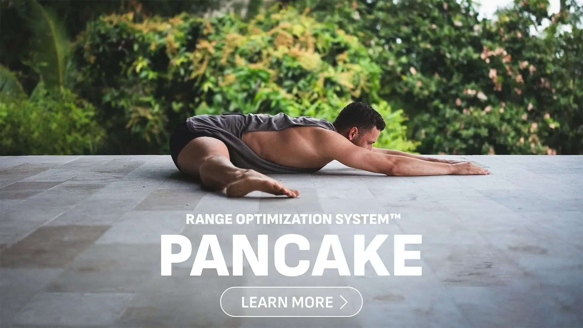 Athlete performing a full pancake stretch using ROS™ flexibility techniques.