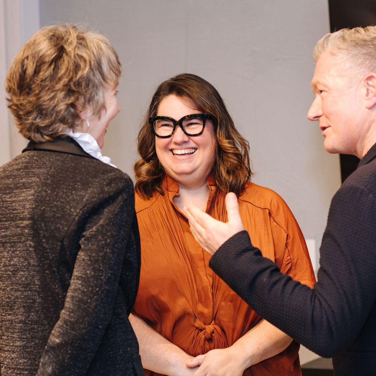 Meredith smiling on stage with audience clapping