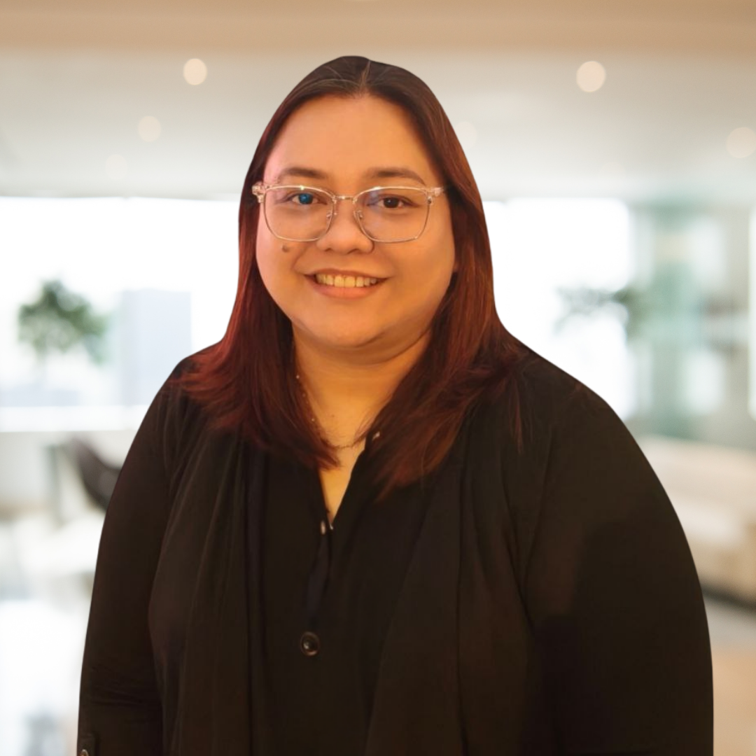 Photo of Kline Dante, who offers Digital Marketing and Operational Support. Dante smiles outside while wearing a patterned red shirt.