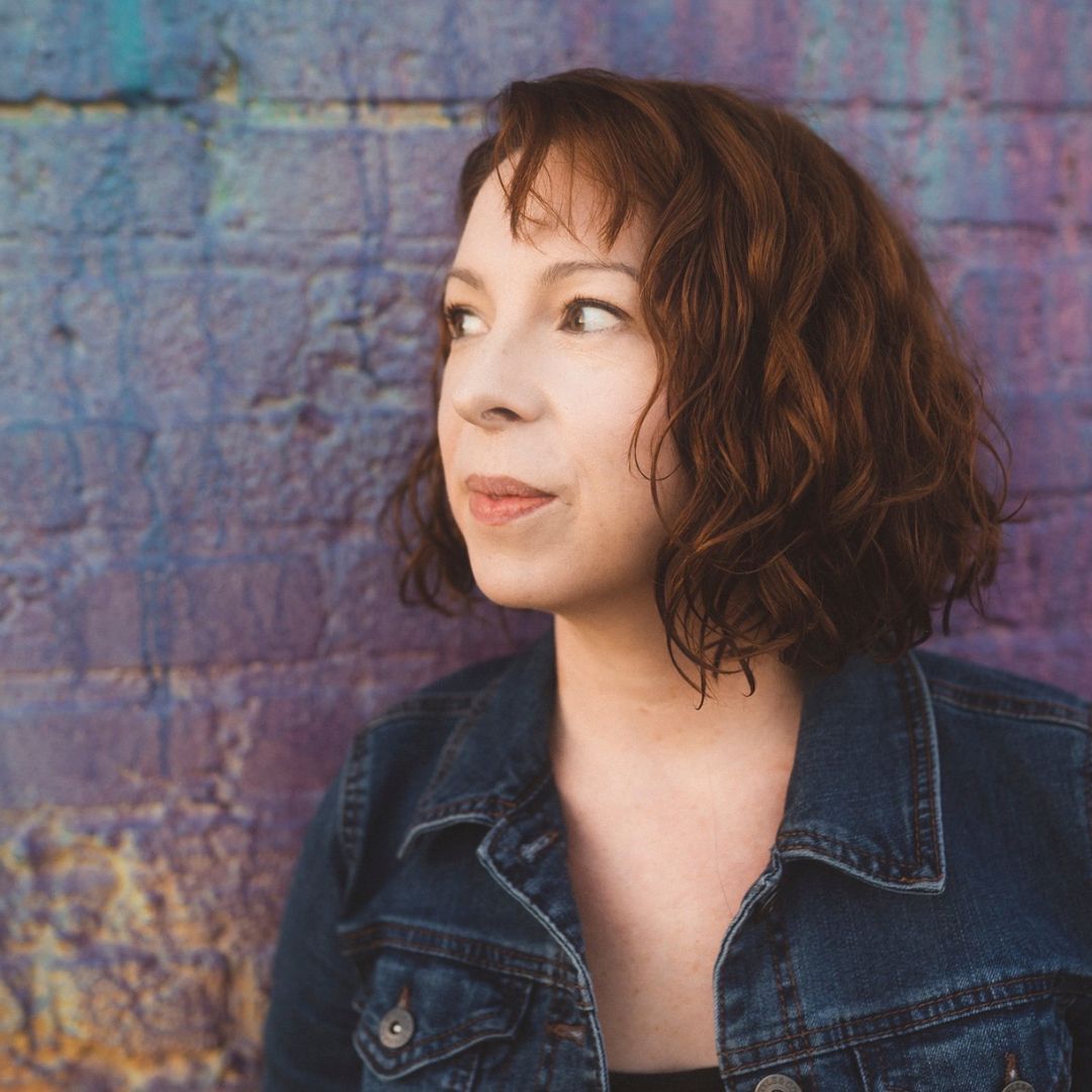 about_heather mays intuitive artist animal communicator medium channeler_woman in front of purple brick wall