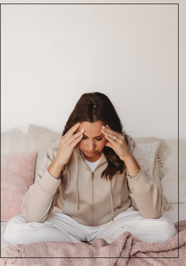 Dr Sheena experiencing fatigue and stomach pain, symbolizing gut health issues, bloating, hormone imbalance, and autoimmune struggles often seen in women seeking functional medicine support