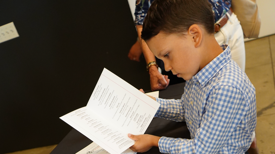 Young pianist reviewing music from a side angle