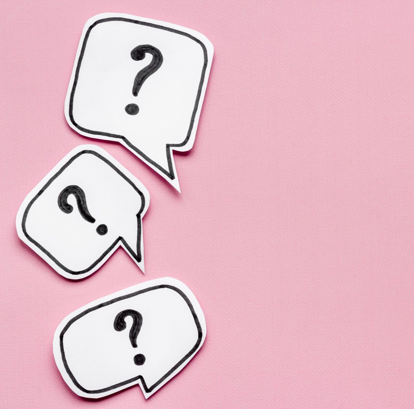 question marks on a pink background