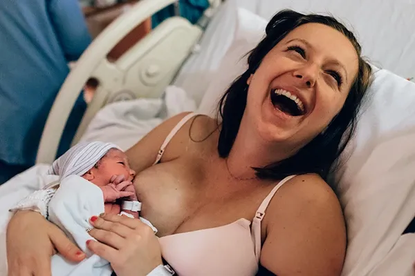 Woman breastfeeding her baby on seat