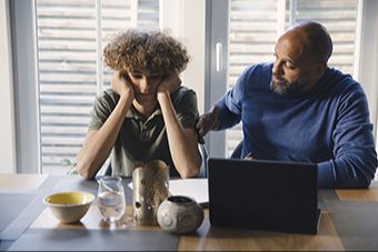 Erin and Chris Verdis, life coaches for parents, teens, and young adults, walking together and smiling.