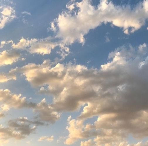 Blue sky with moving clouds, symbolizing thoughts and the space of awareness behind them