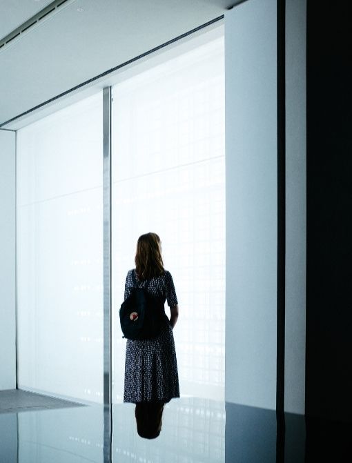 person standing in a modern hallway looking forward