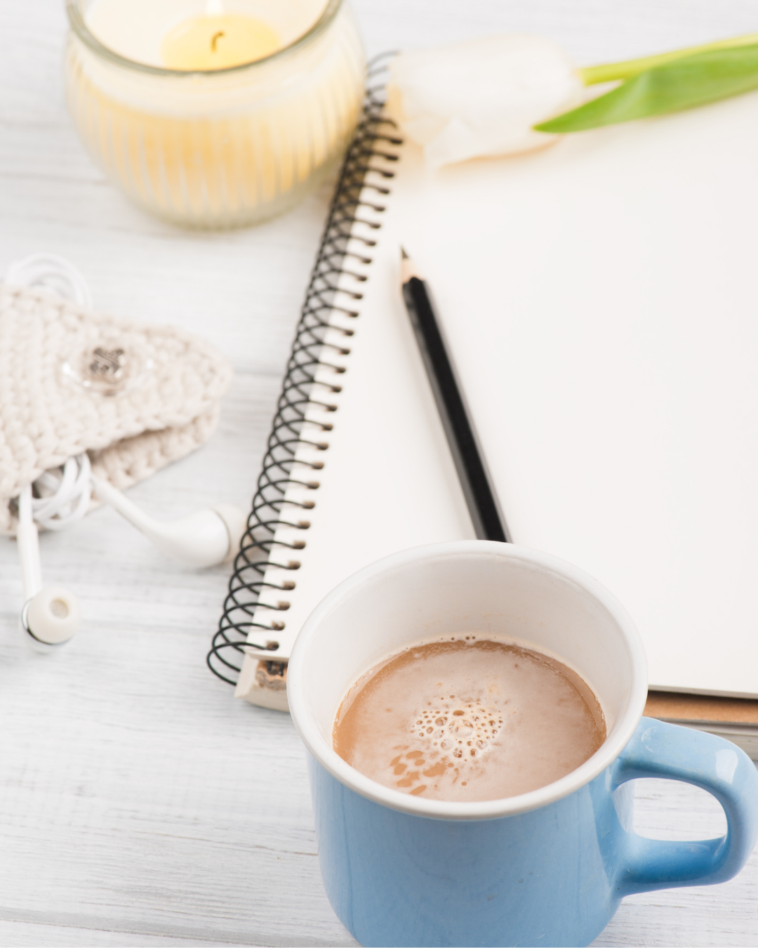 notebook and pen with a cup of coffee