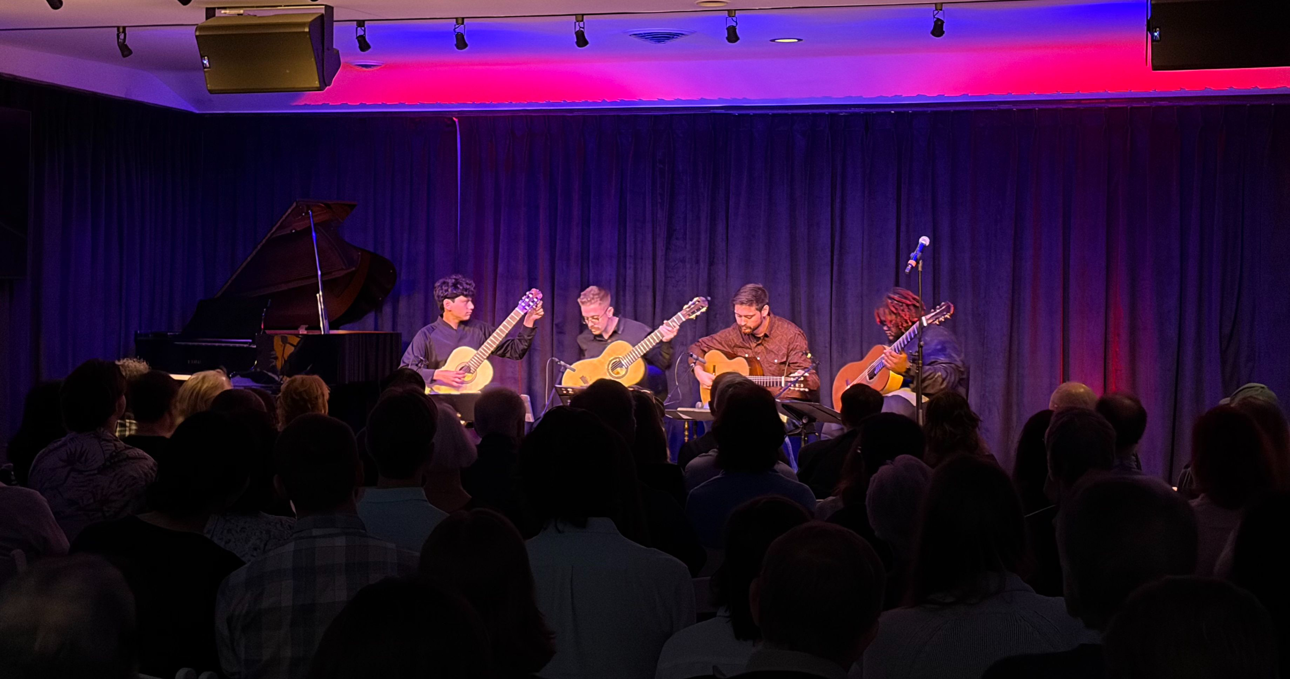 Guitar quartet playing a concert at paper moon event hall
