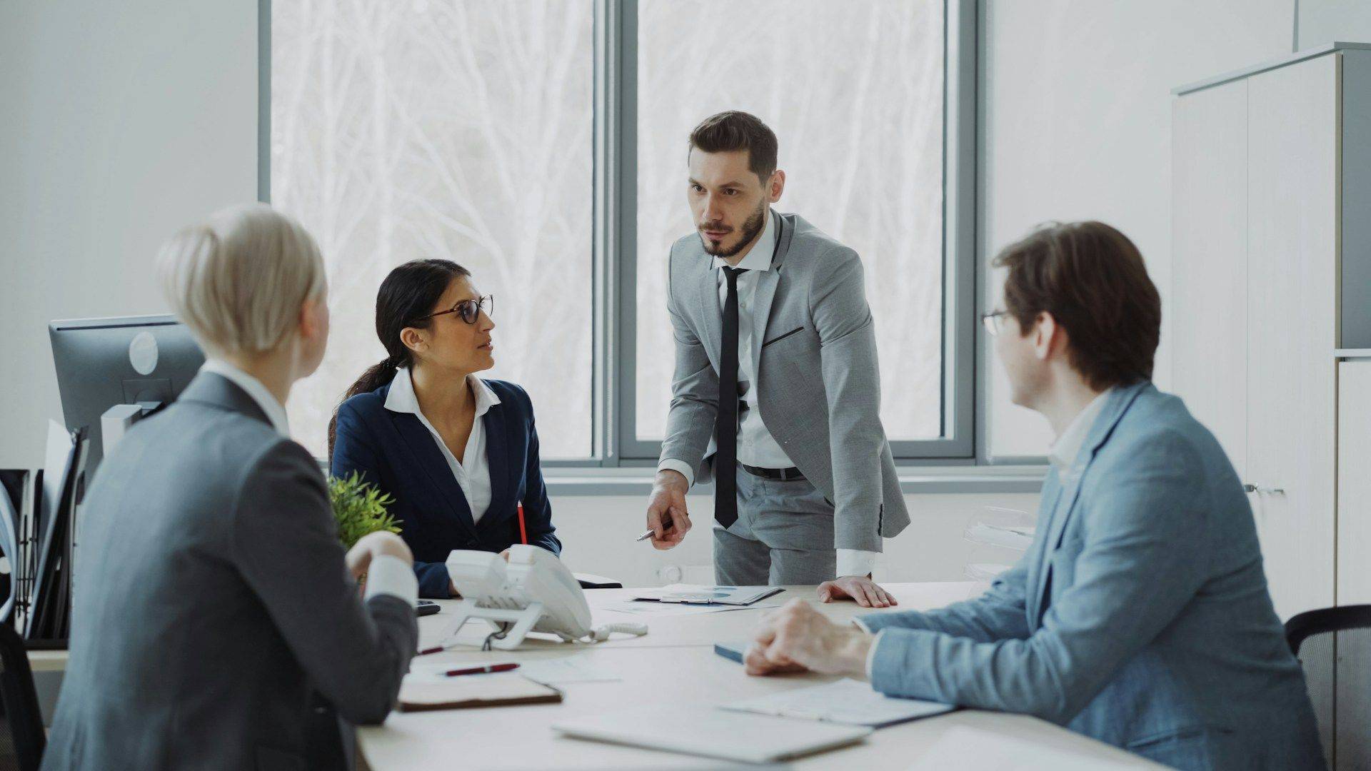 A professional presenting confidently in a meeting