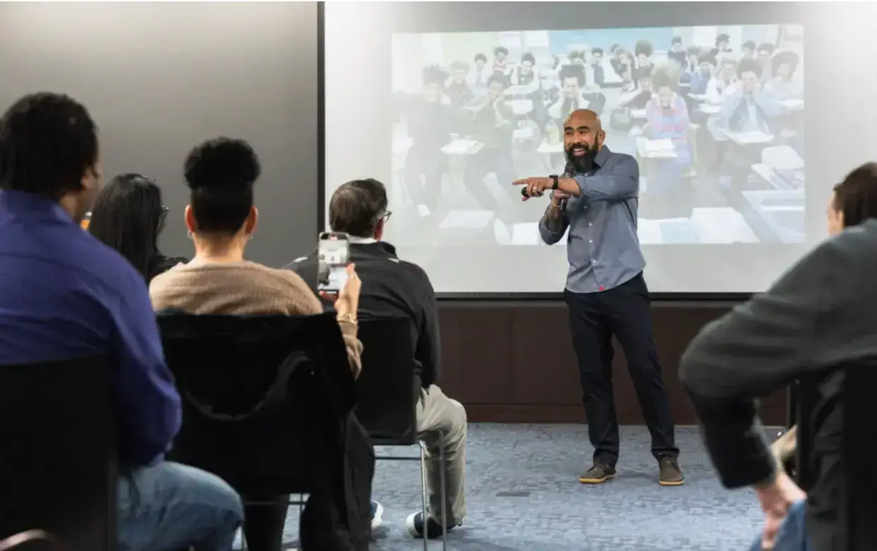 Chris Romulo delivering a corporate keynote workshop on resilience to a seated audience