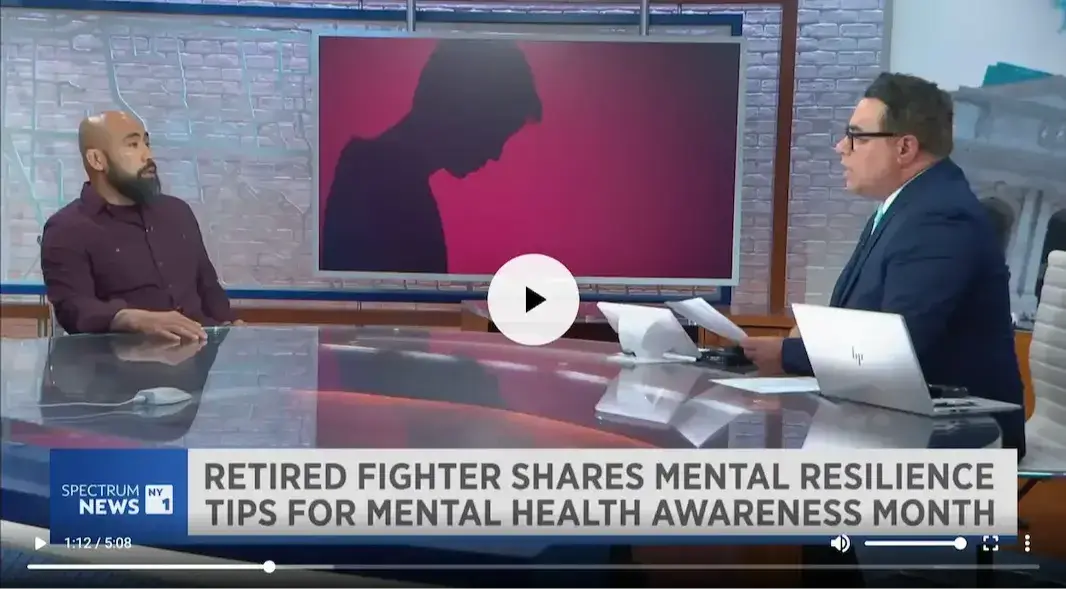 Chris Romulo on a televised news interview discussing mental resilience tips for Mental Health Awareness Month