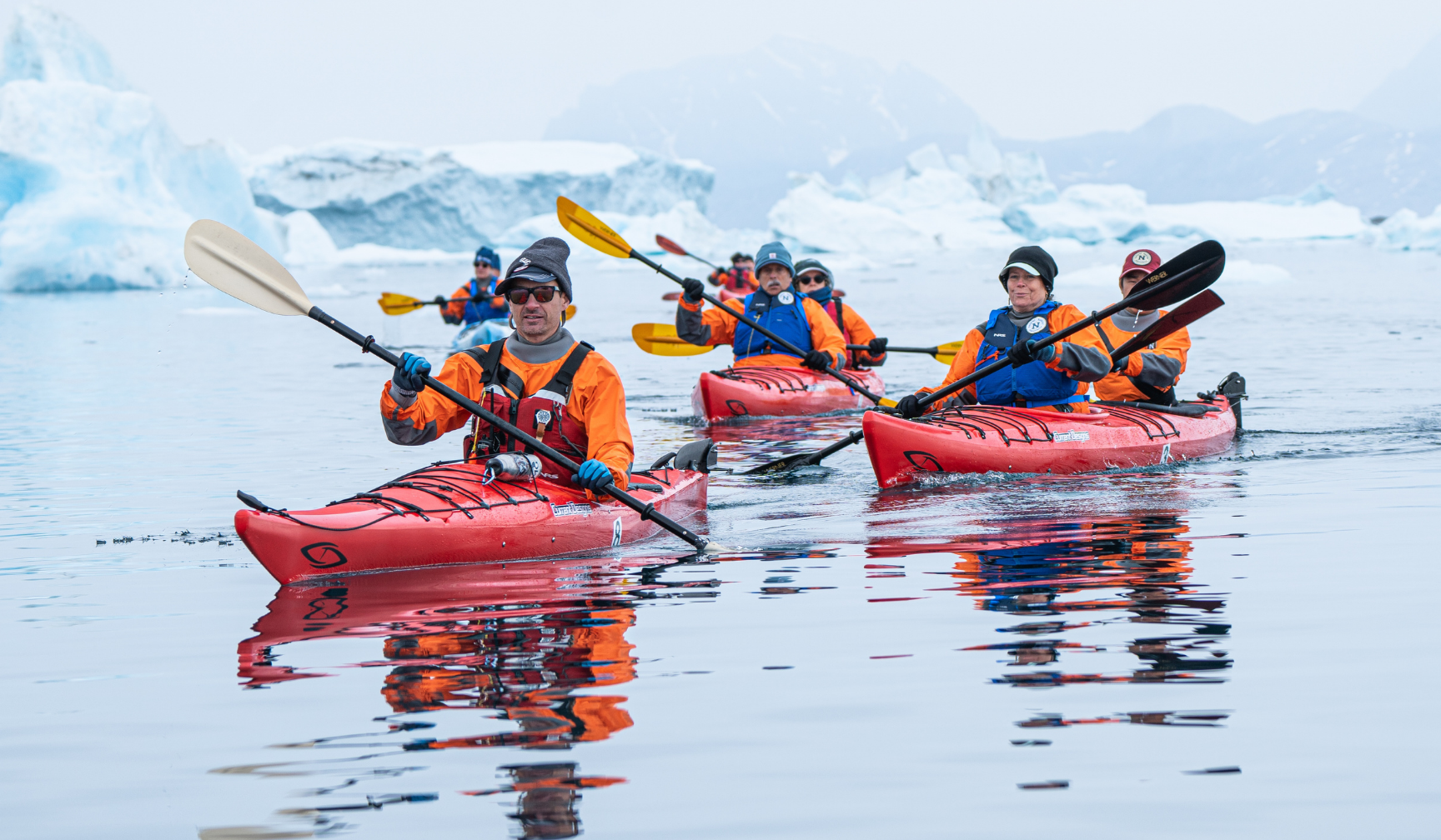 A professional sea kayak guide leads an adventure in the polar wilderness. . 