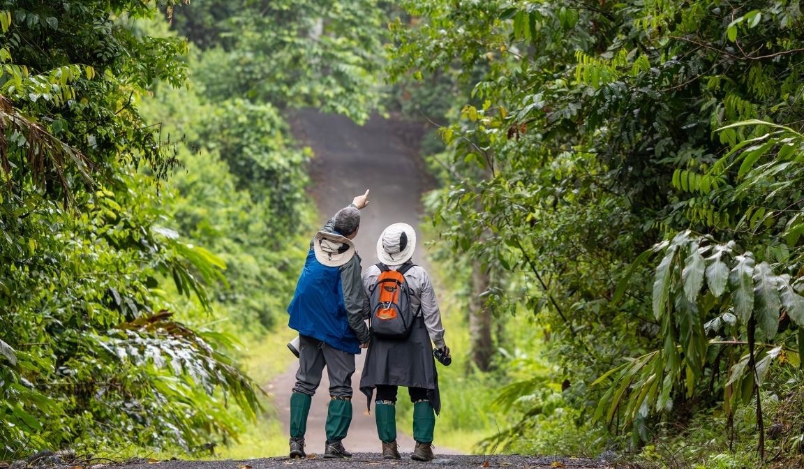 A guide and traveler discussing conservation during a sustainable travel trip. 
