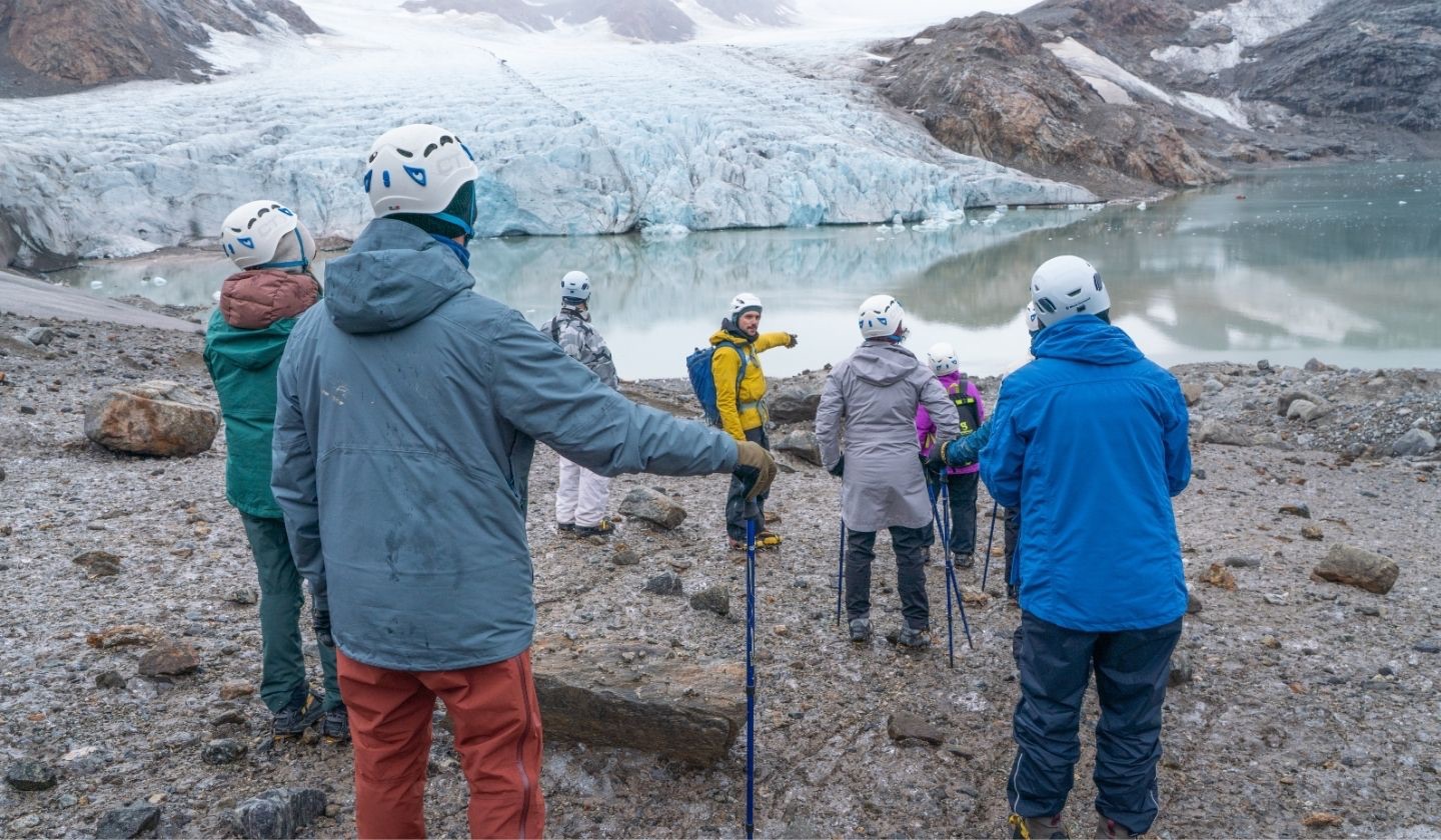 Professional wilderness guide using interpretation skills for conservation to travelers in a national park
