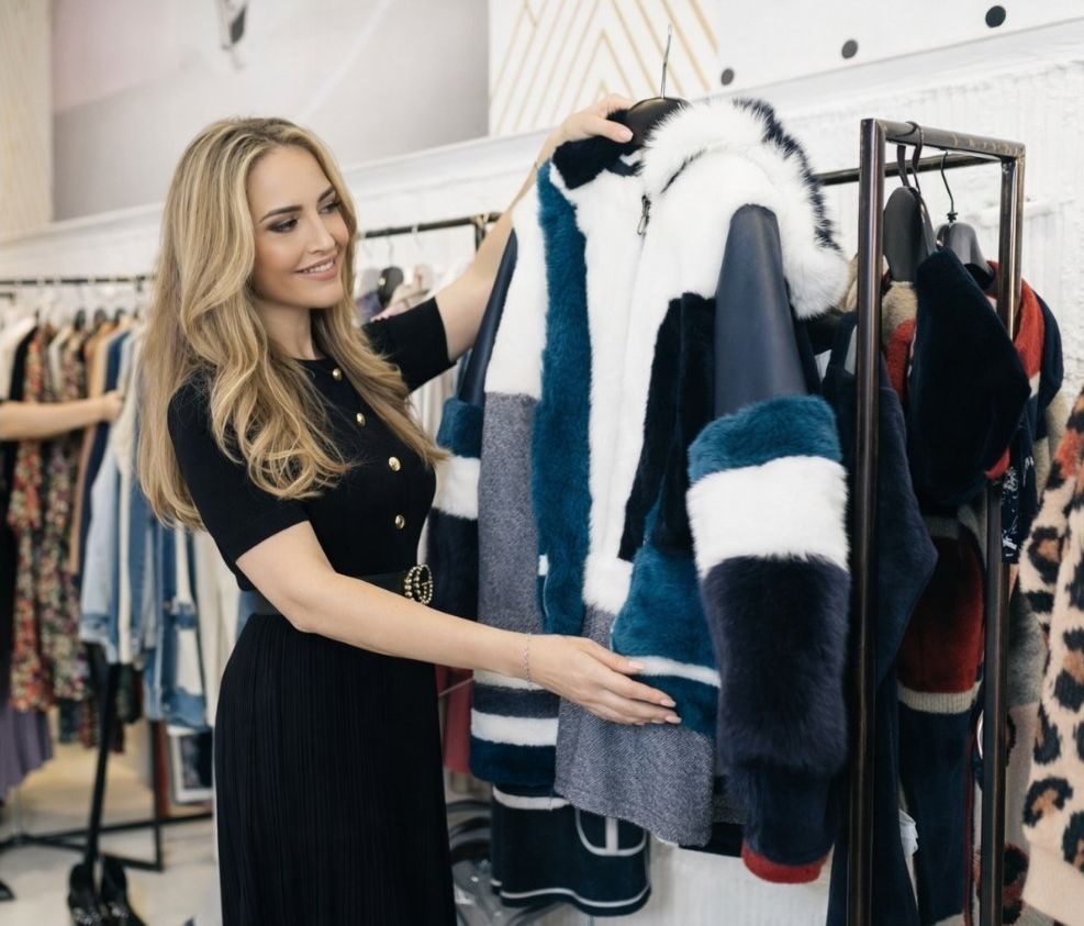 San Diego personal stylist selecting a jacket during an in-store styling session
