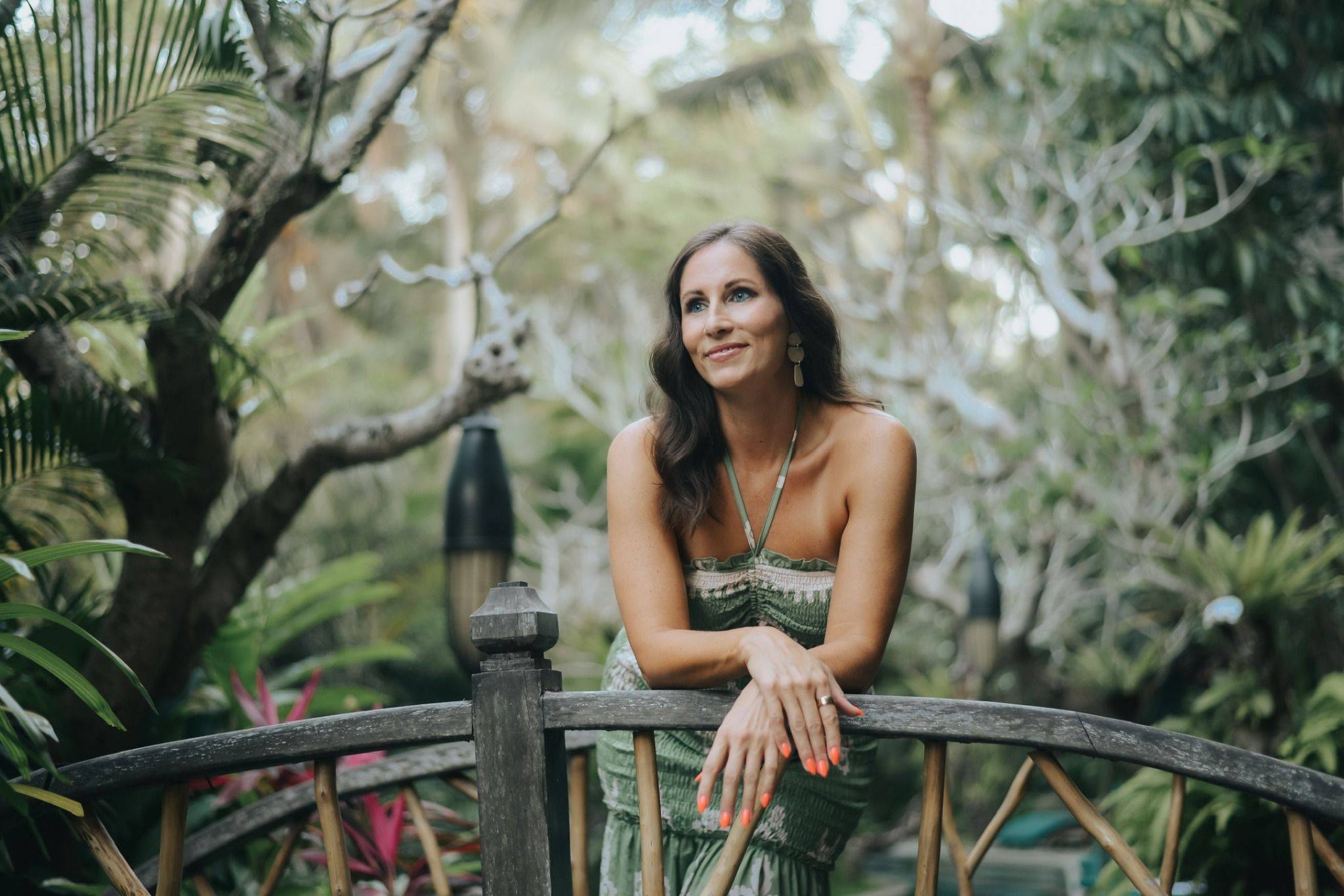 Lauren Kappel leaning on a wooden railing in Bali