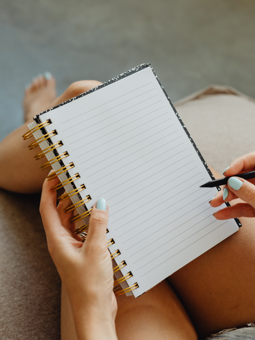woman writing in a notebook representing content creation and coaching