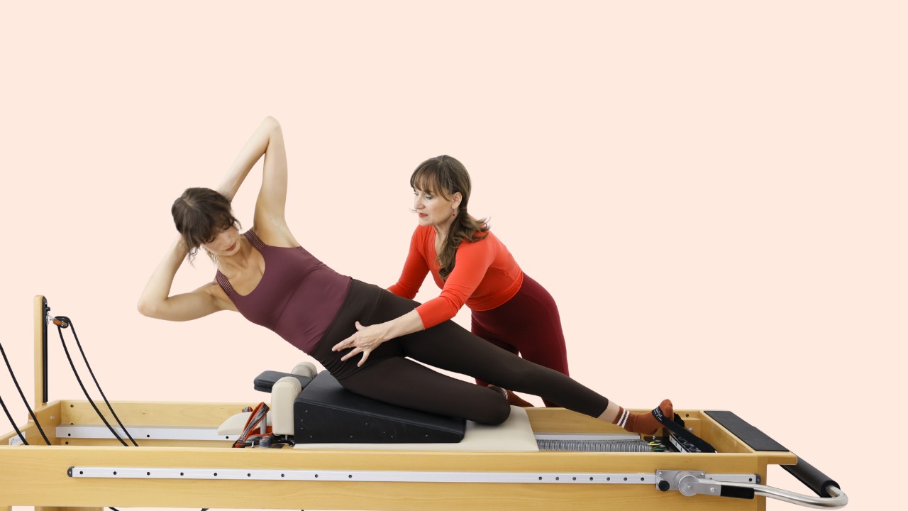 Louise Taube teaching side overs on the Pilates Reformer