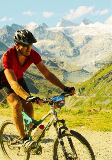 Core Strength Pilates member Rob cycling in the mountains, staying strong and active through Pilates.