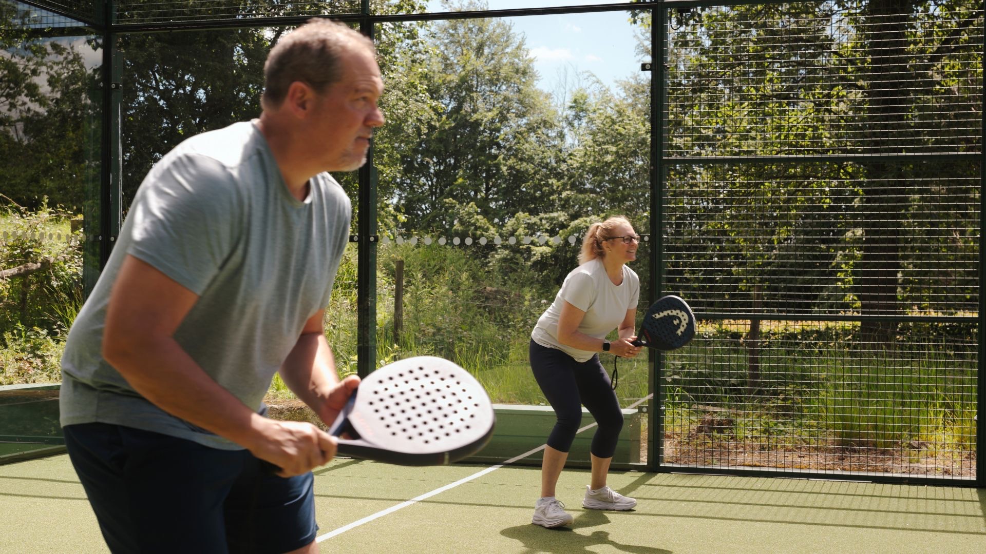Two people playing padel, enjoying an active lifestyle and the sports they love, padel.