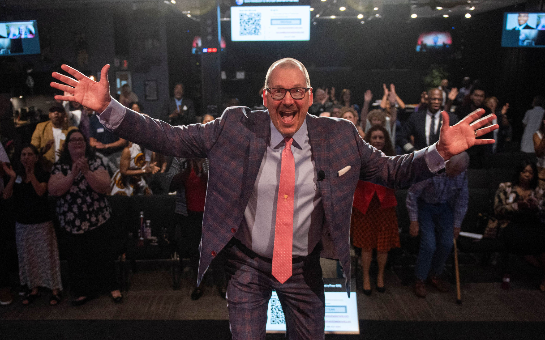 Michael energizing an audience during a keynote.