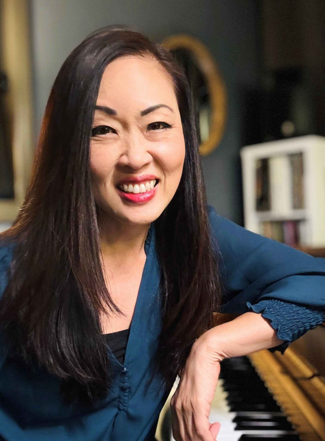 Kristina Lee, pianist and piano educator, seated at piano