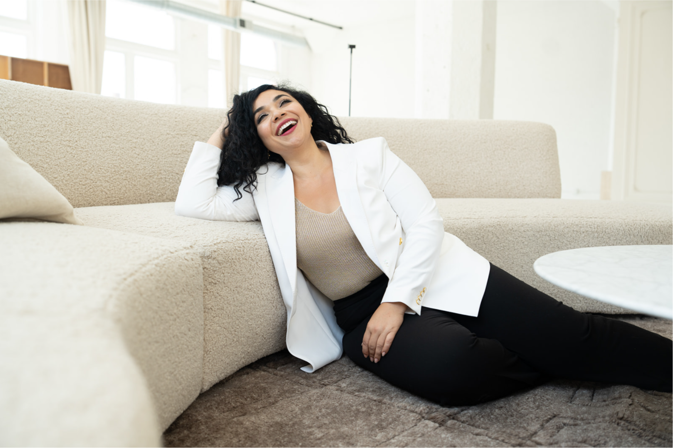 Dunya laughing on a couch
