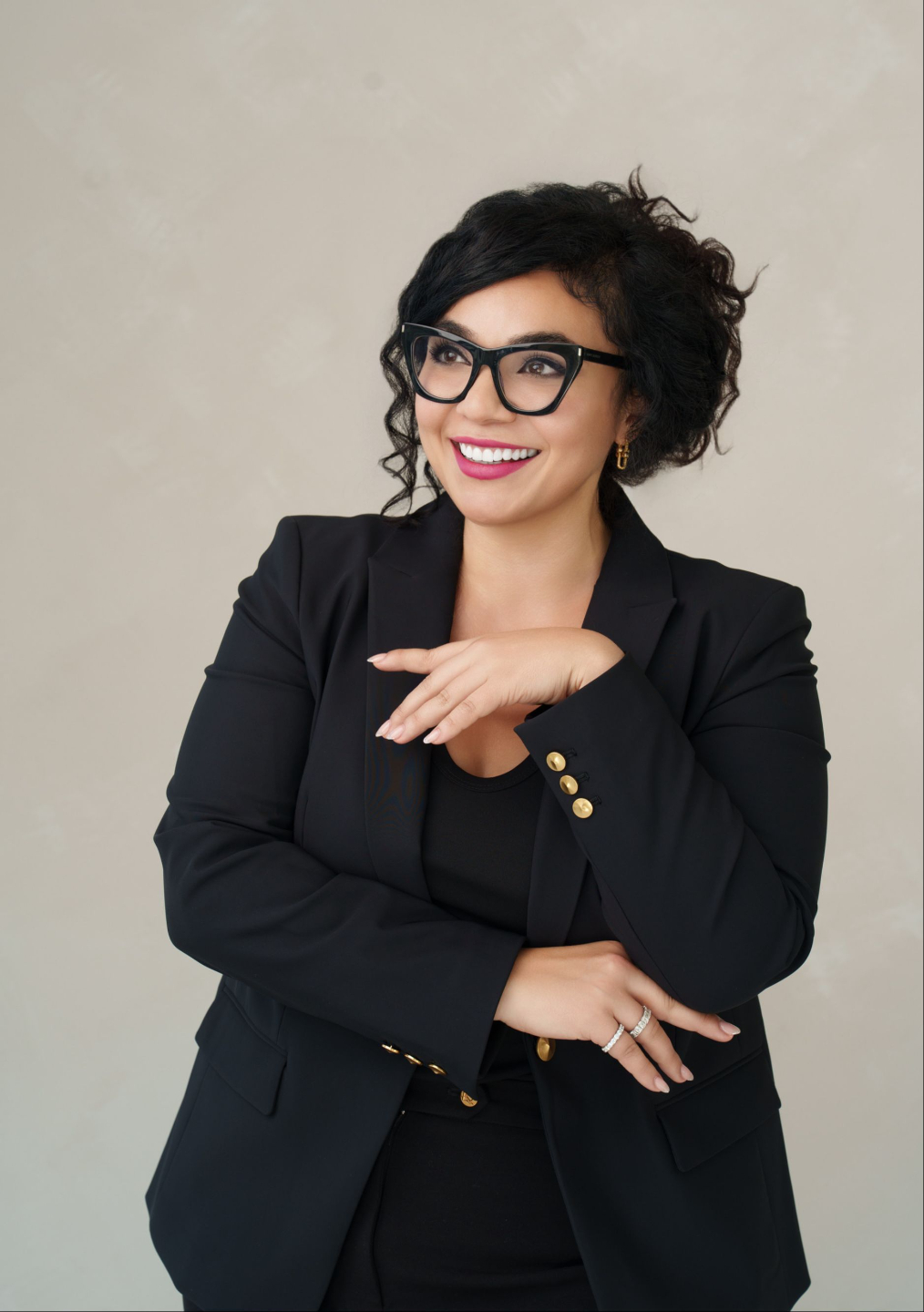 Dunya Daikhi seated in professional attire