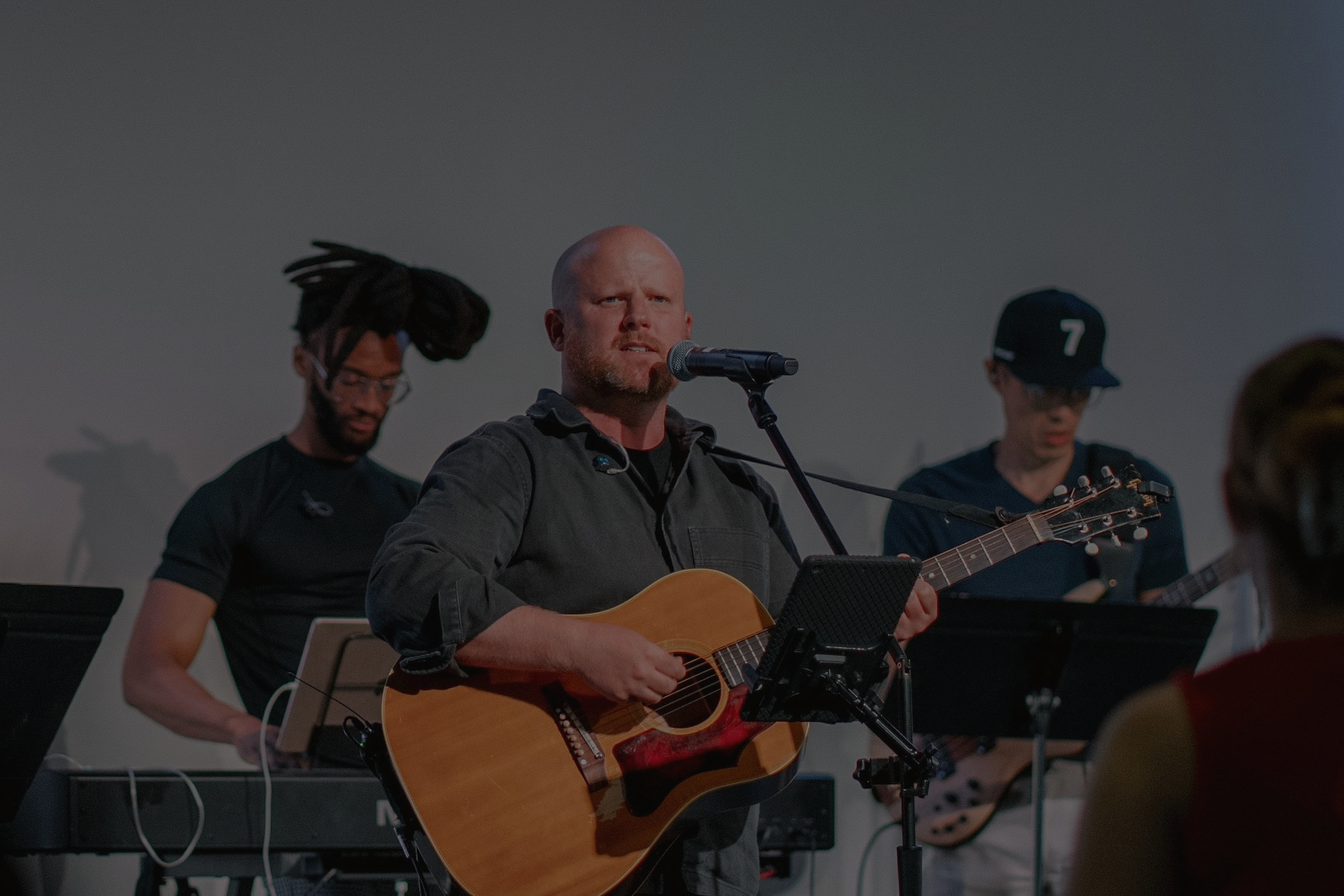 Patrick Murphy leading worship with an acoustic guitar