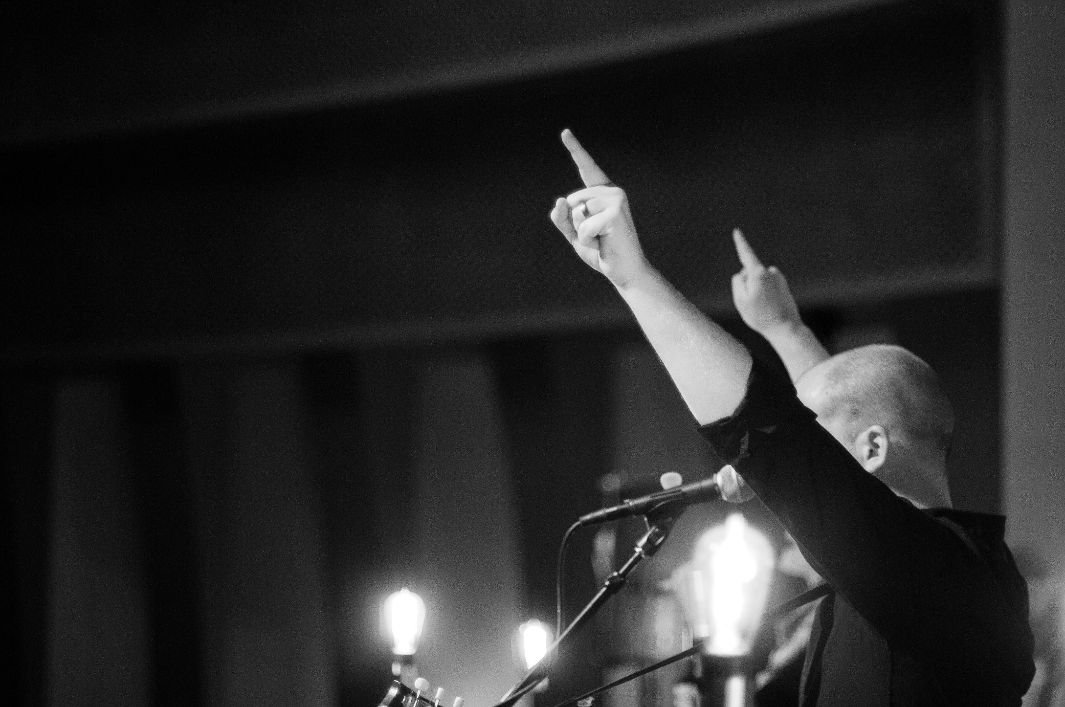 Patrick Murphy with his hand raised in worship