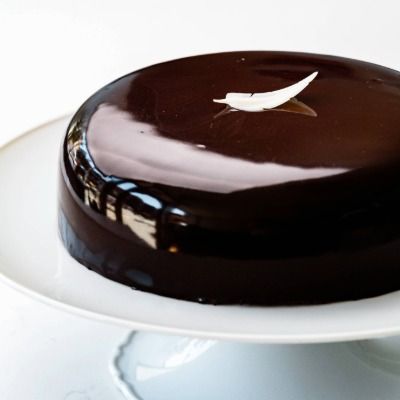 Modern chocolate entremet with mirror glaze showcasing premium dessert design.