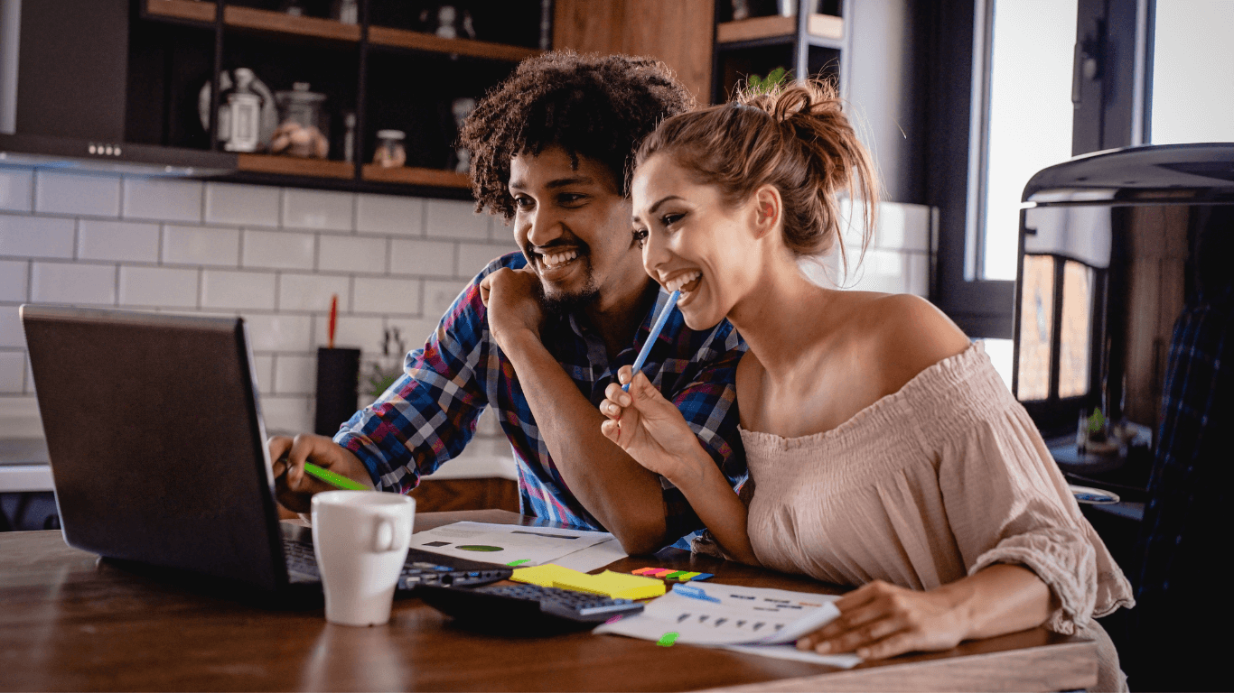 Married copy planning in the kitchen on the computer after meeting with an ADHD Coach for Executive Function Coaching in New Jersey | ADHD Coaching for Adults | Executive Function Coaching for Adults | Neurodivergent Coaching | Task Initiation | Planning | Time Management | Prioritizing