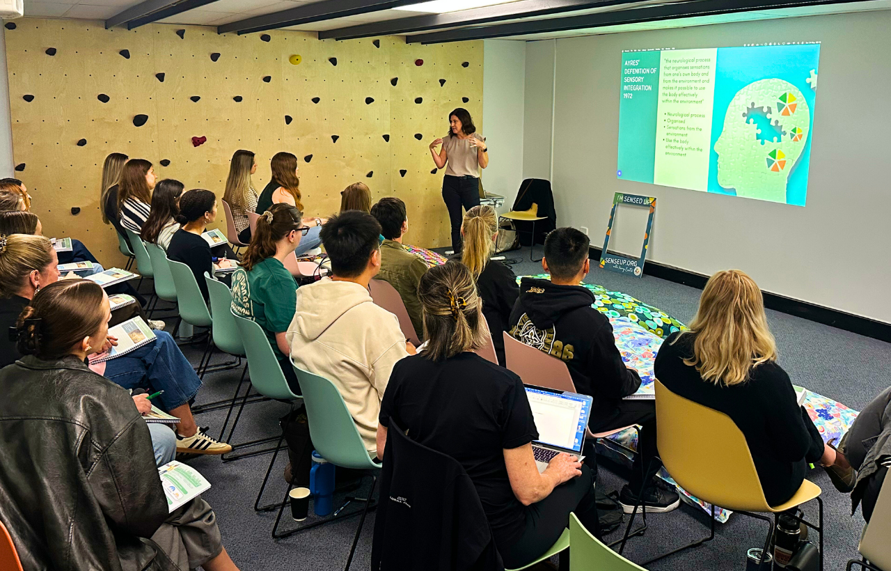 Kerry Evetts Owner of SenseUp presenting Workshop content to a group of workshop attendees in a Practice Setting.