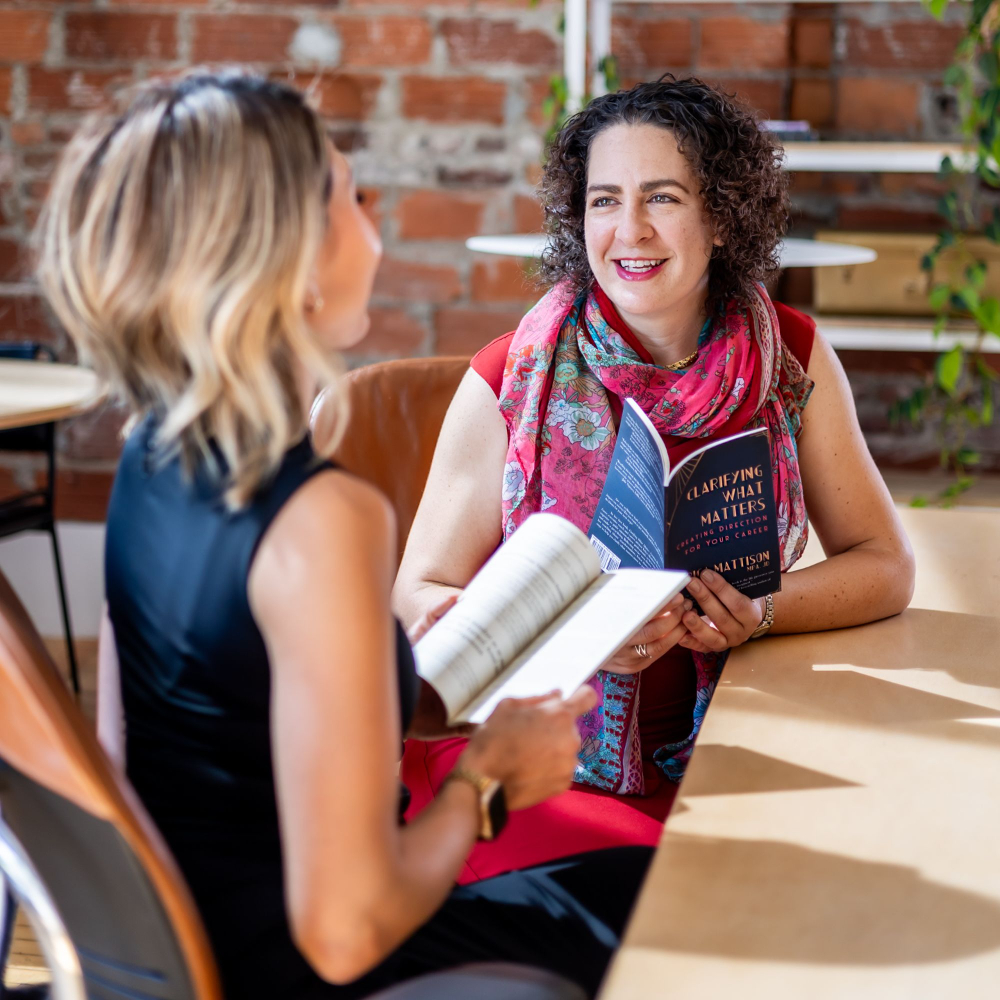 Erica Mattison and a client discuss Clarifying What Matters career book