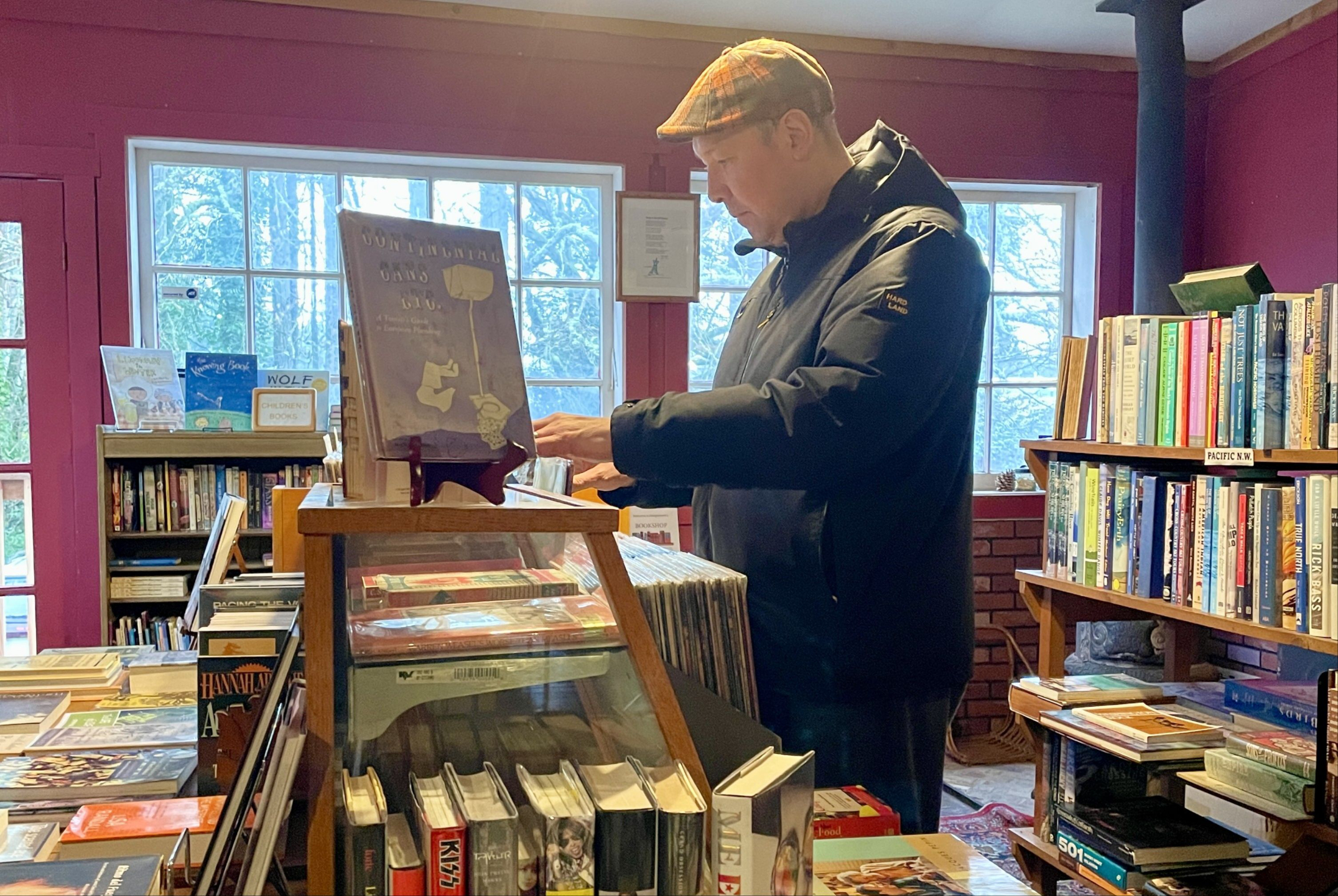 Man peruses records in a bookstore, seeing what sparks his curiosity