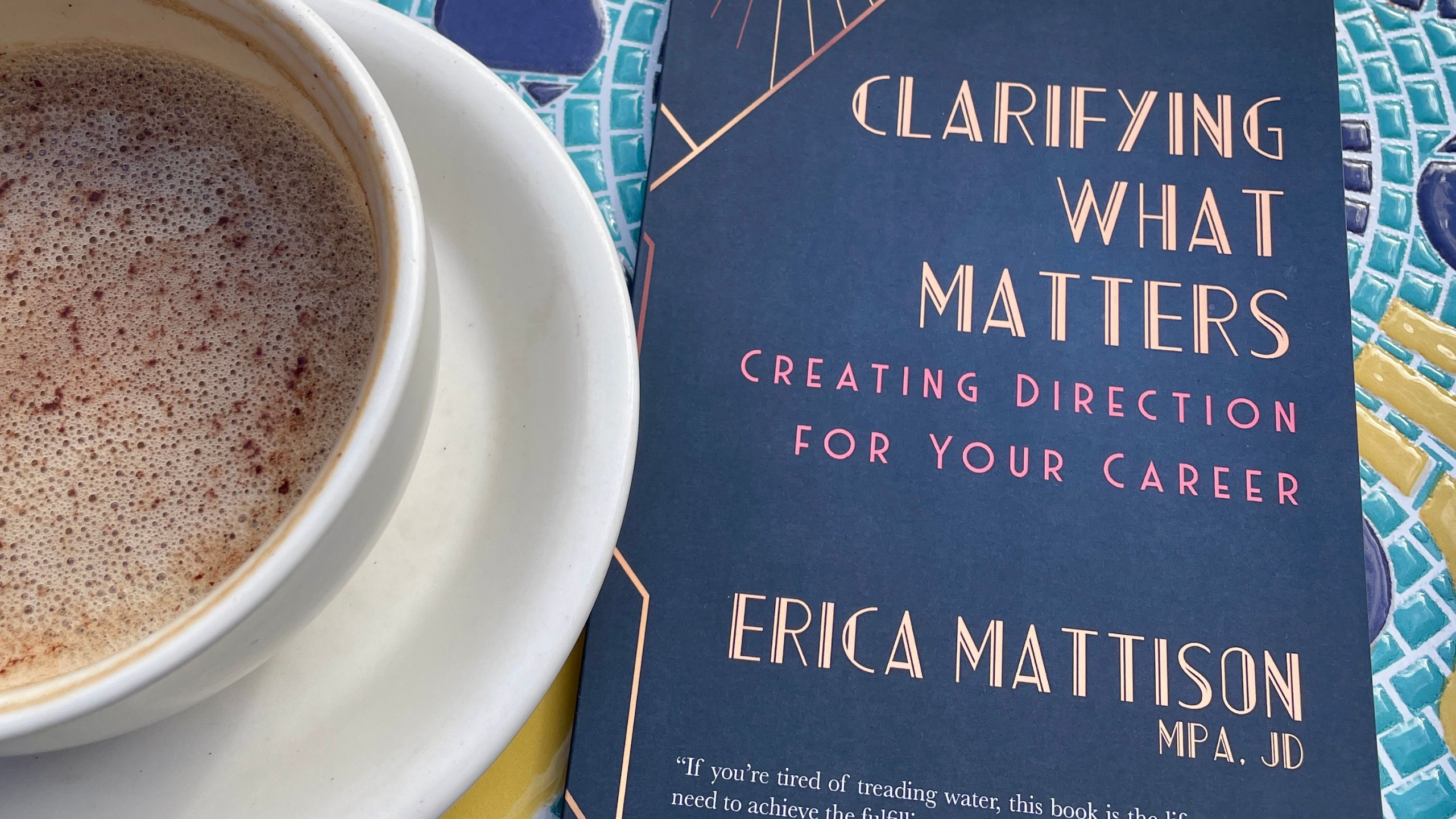Clarifying What Matters career clarity book by Erica Mattison at a café table with a warm beverage