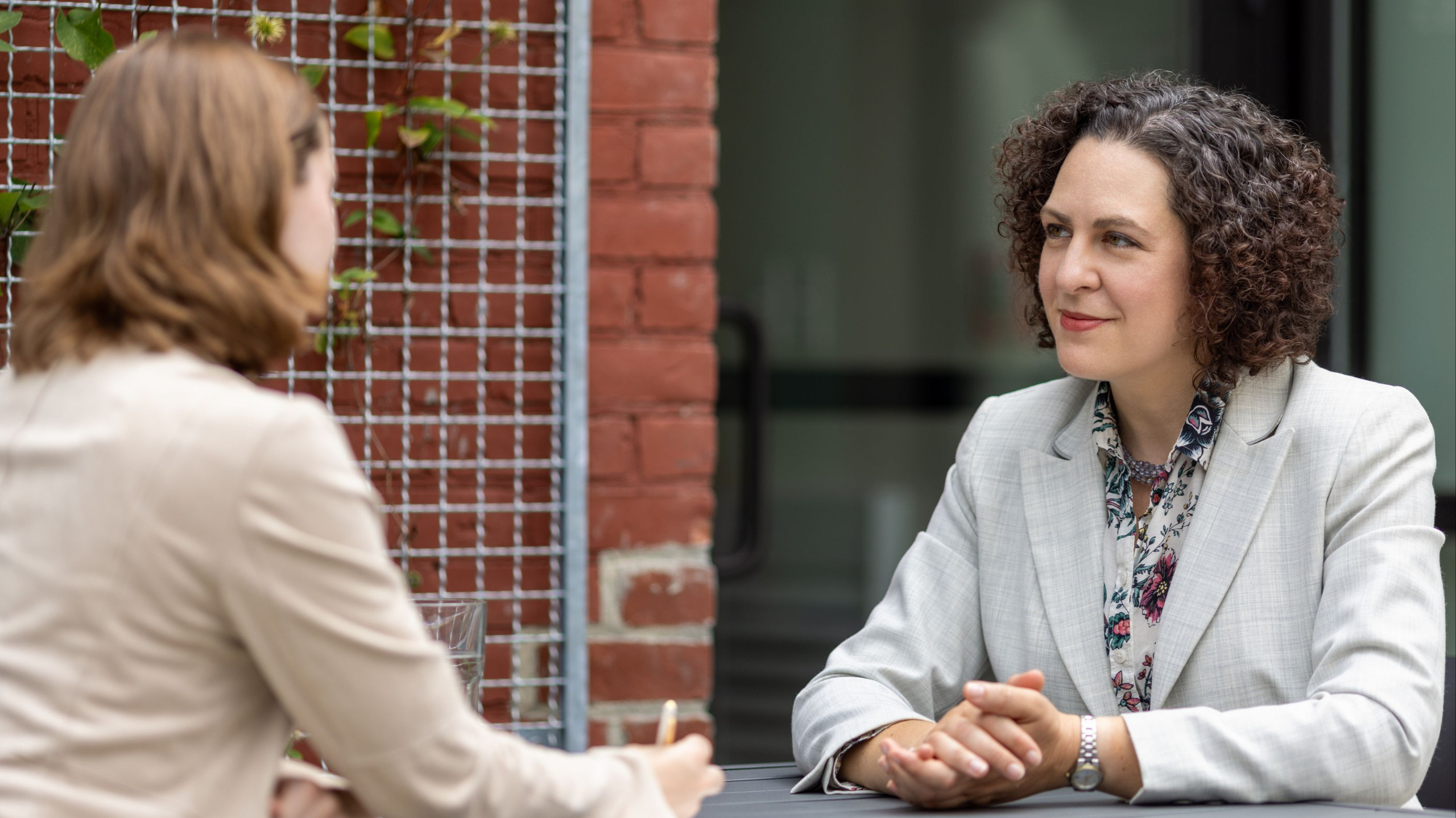 Executive coach Erica Mattison speaking with a professional client