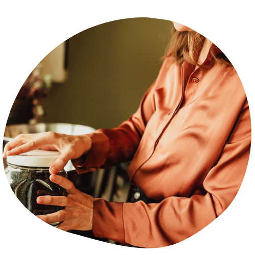 Person preparing food in a kitchen, representing daily healthy habits and nutrition