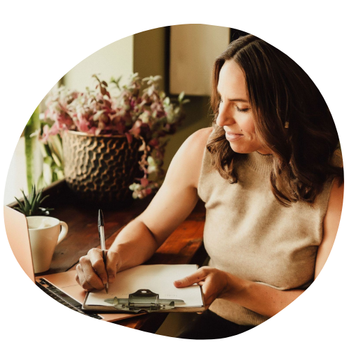Woman working on a laptop with coffee, representing starting a health journey