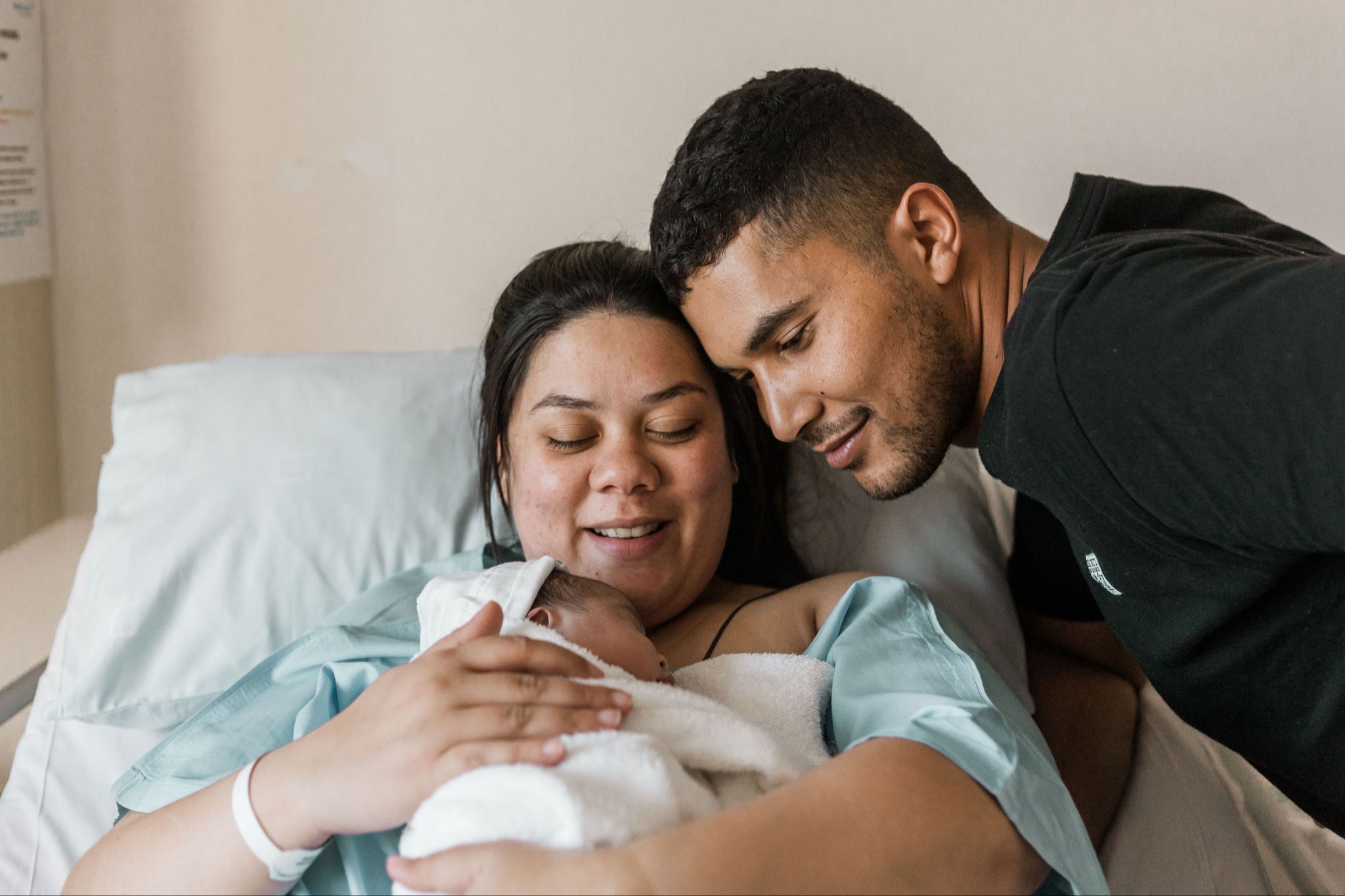 Mother and father in hospital with newborn baby