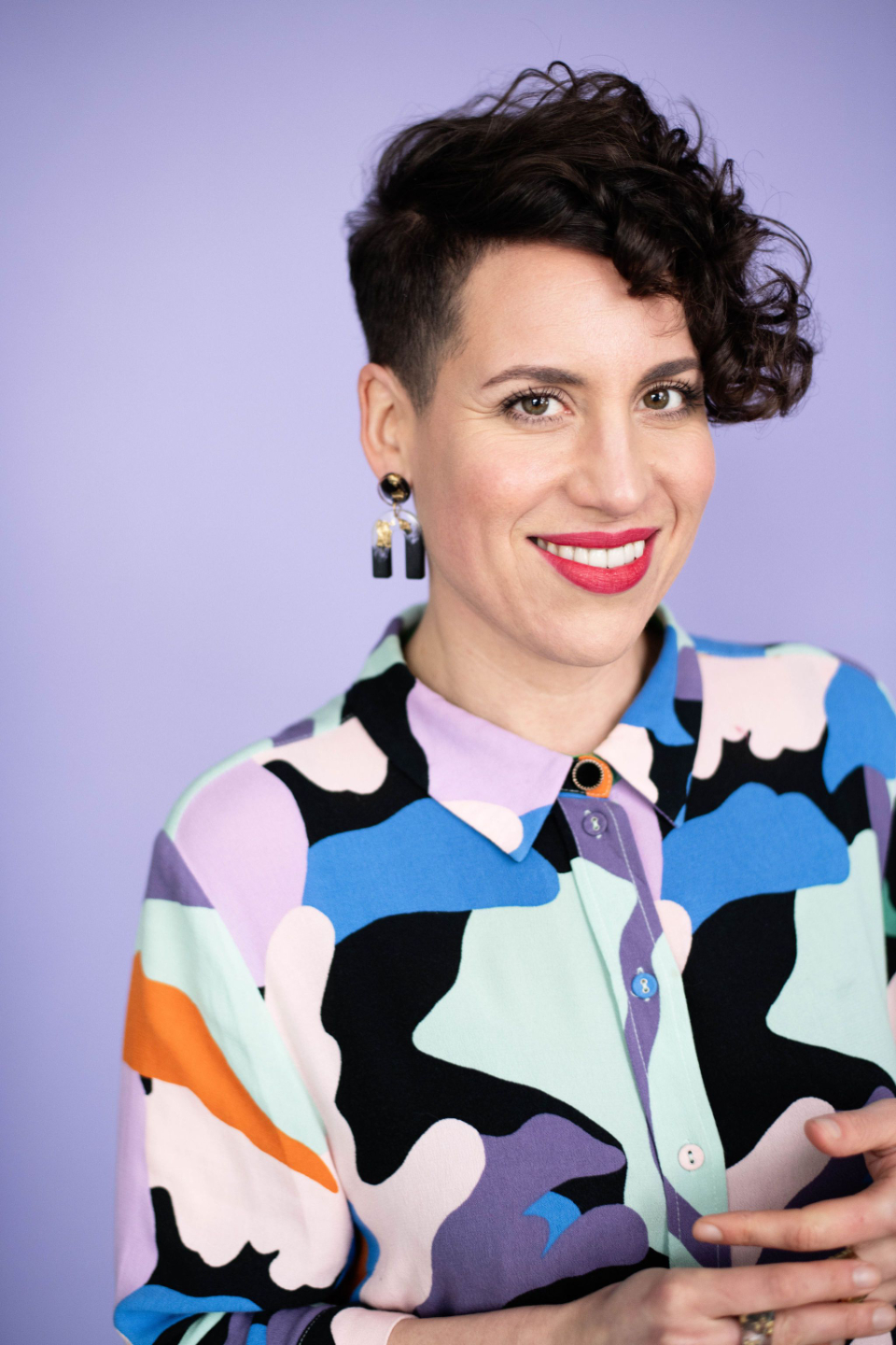 A photograph of Jess Rad. She is looking at the camera and smiling.