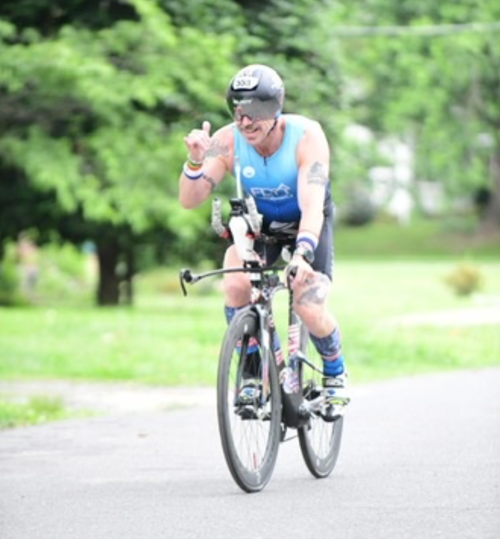 Person standing on mountain with dog taking in an incredible view