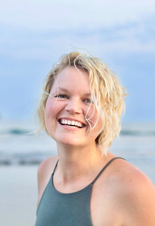 woman smiling on beach representing happy energy