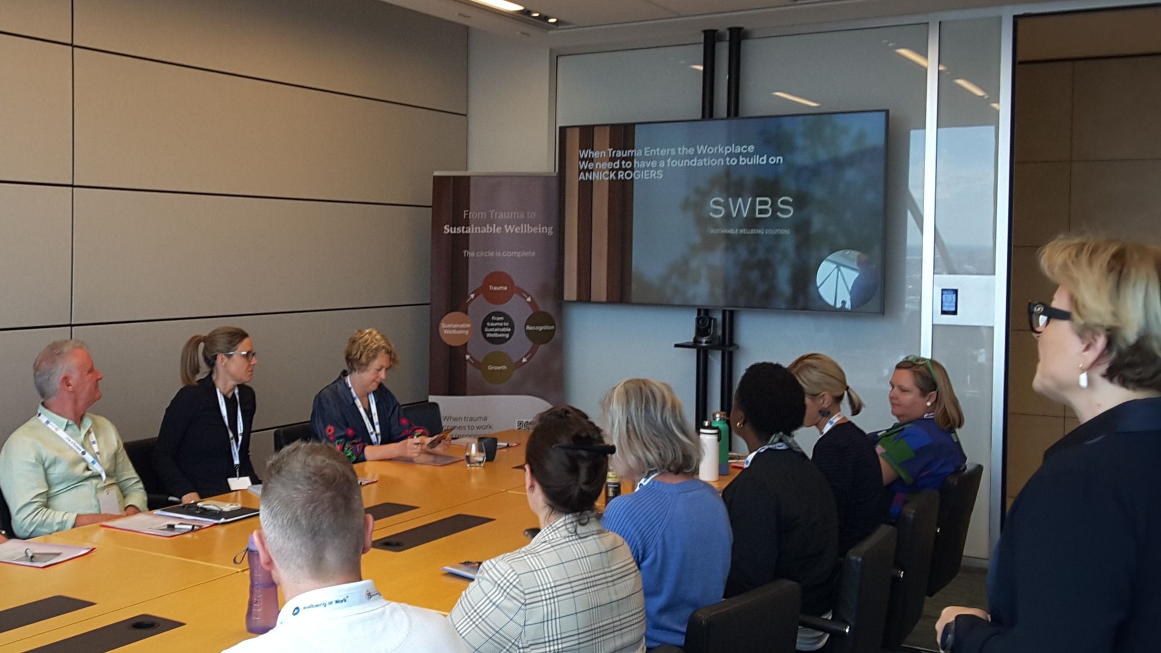 Keynote speaker presenting on trauma-informed leadership to a live audience