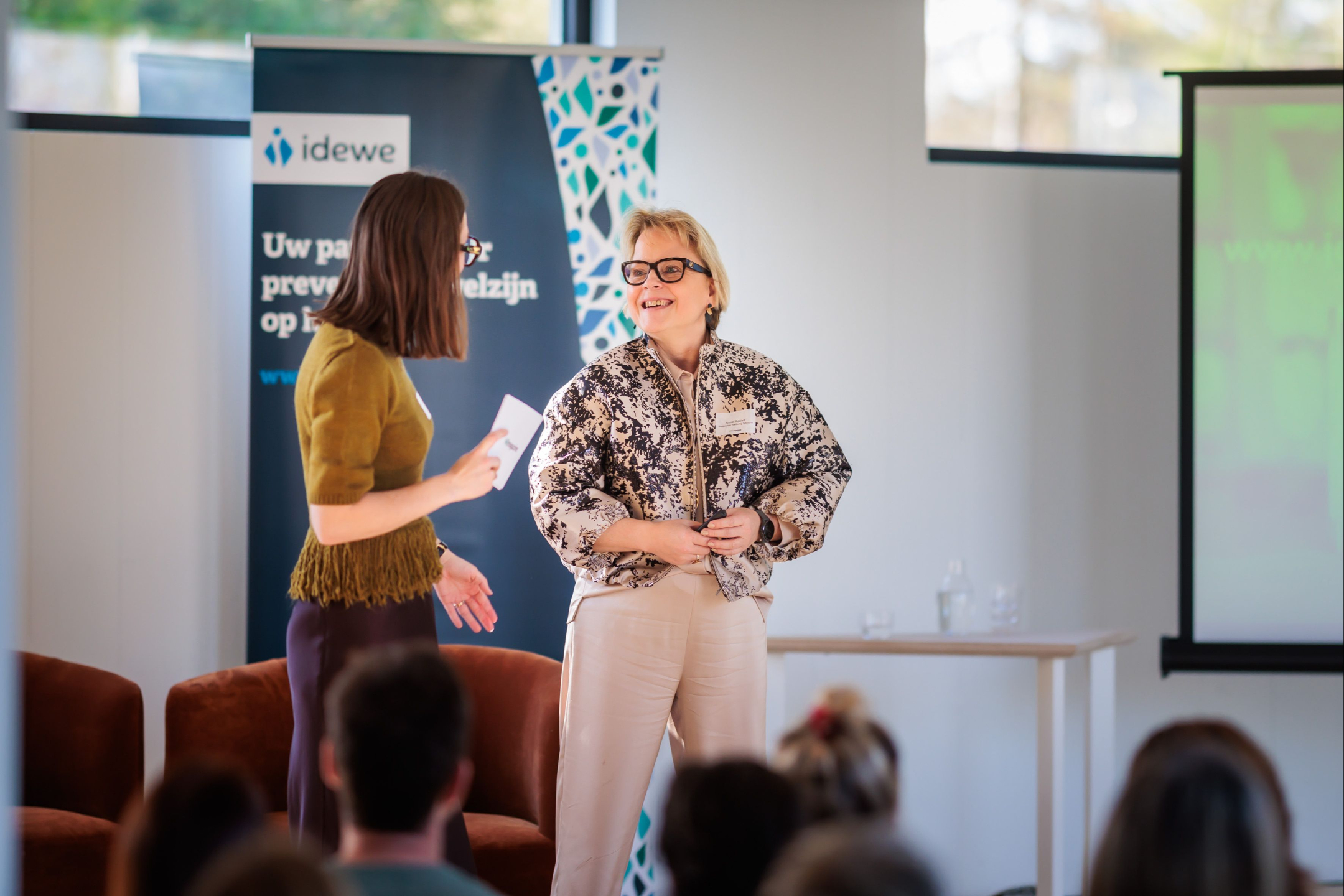 Person holding a sign with the text "A journey of transformation"