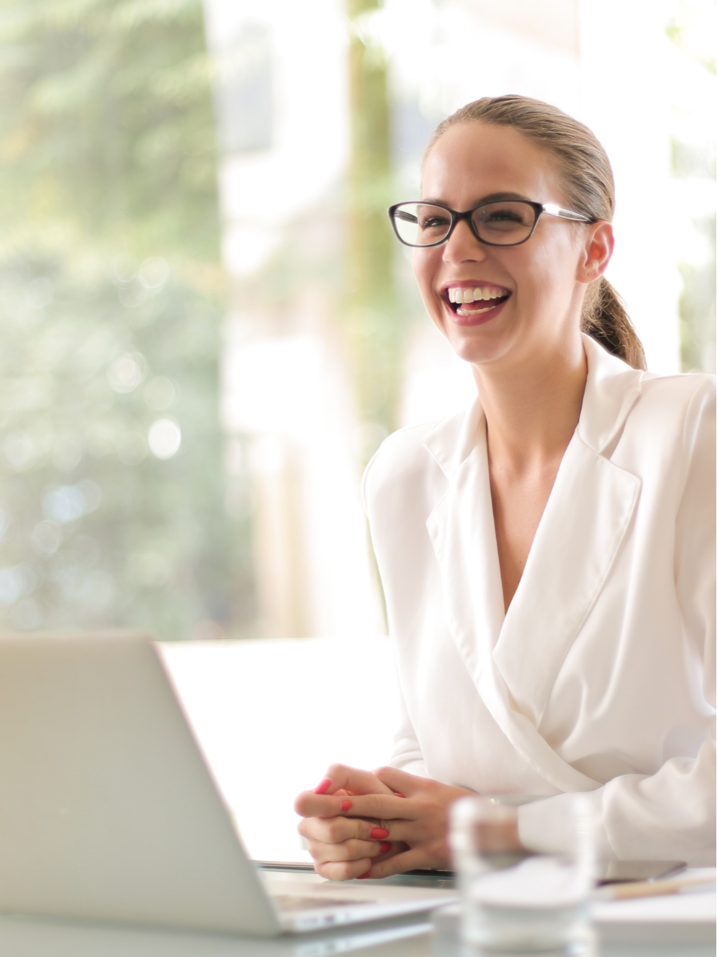 Woman with Glasses smiling at the camera
