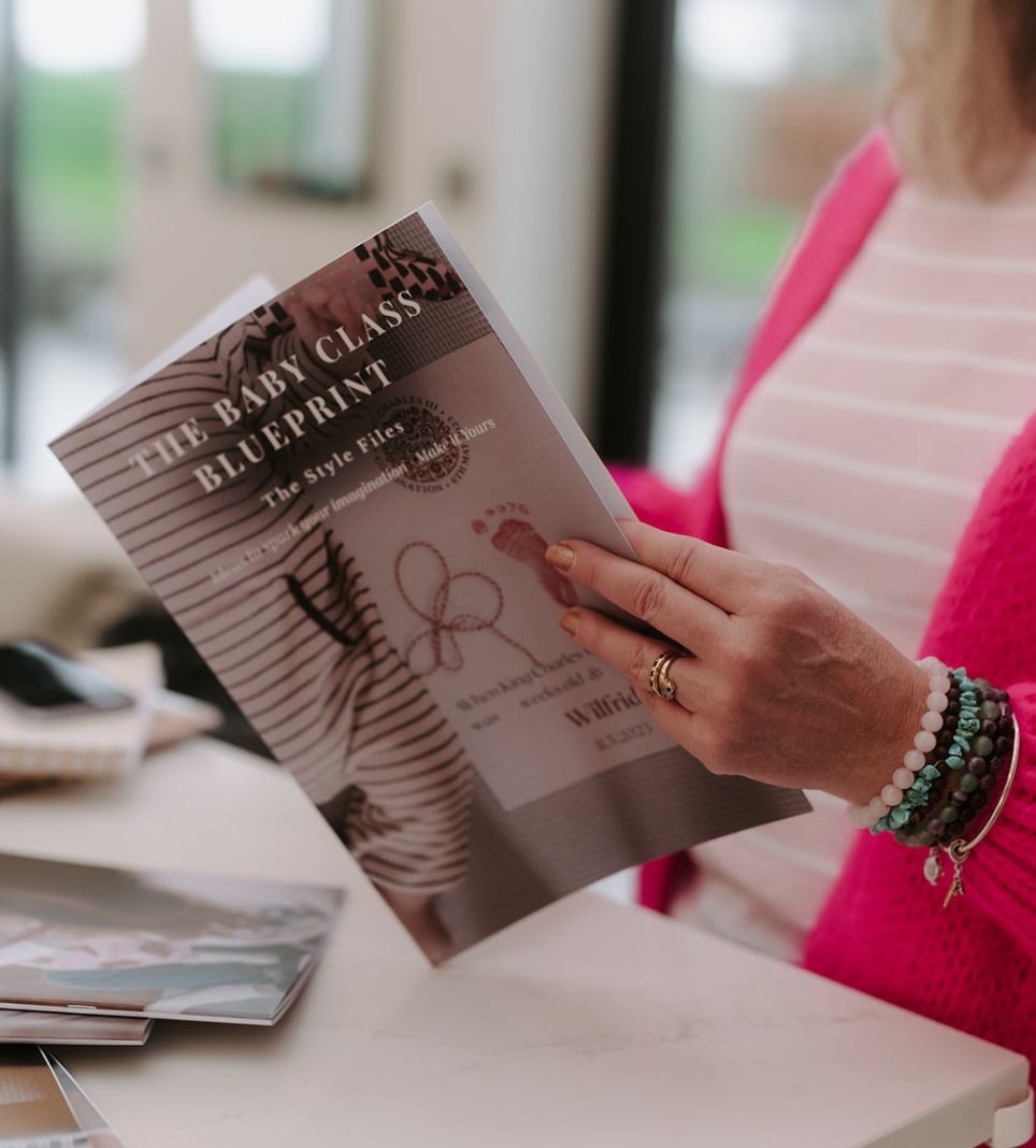 Elizabeth James holding the Baby Class Blueprint training guide for baby class teachers